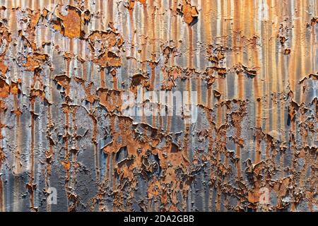 Rusty metal background or texture with peeling paint, iron plate from an old locomotive Stock Photo