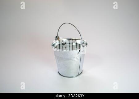 Silver bucket on a white background with a handle Stock Photo