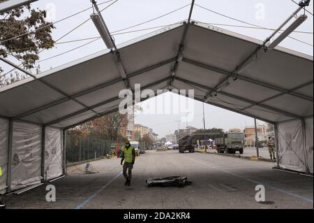 Milan, November 2020, Italian Army, units of NRDC (NATO Rapid Deployable Corps) mount a drive-trough structure for the collections of swabs for the diagnosis of Covid-19 virus in a subway parking area. Stock Photo