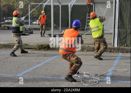 Milan, November 2020, Italian Army, units of NRDC (NATO Rapid Deployable Corps) mount a drive-trough structure for the collections of swabs for the diagnosis of Covid-19 virus in a subway parking area. Stock Photo