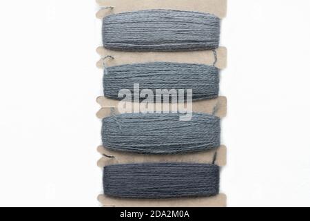 Set of sewing threads on white background, top view, close up. Gray colors gradient. Stock Photo