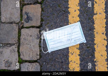 Windsor, Berkshire, UK. 7th November, 2020. The familiar sight of a discarded face mask. Windsor was much busier today on the third day of the new Covid-19 Coronavirus lockdown. A lot more shops and cafes were open than during the first lockdown. Credit: Maureen McLean/Alamy Stock Photo