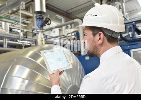 businessman checking factory interior in an industrial plant Stock Photo