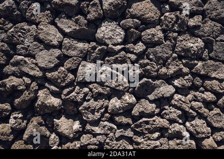 Stones texture and background. Old lava stone wall. Stock Photo