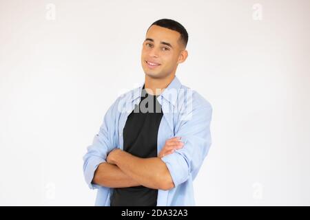 Portrait of happy handsome man in blue shirt crossing hands and look at camera Stock Photo