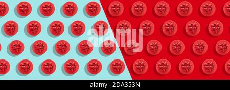 Pattern red gift box with decorative bow on blue and red surface flat lay. Holiday concept new year or Christmas gift box presents Xmas holiday, long Stock Photo