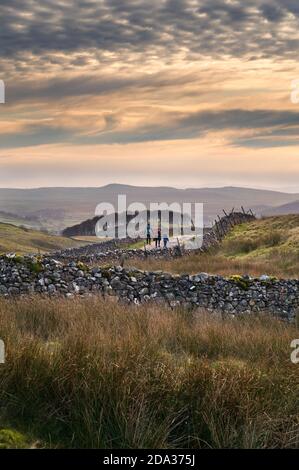 Walkers walking the Pennine Way on an Autumn day near Horton-in-Ribblesdale, Yorkshire Dales National Park, UK Stock Photo