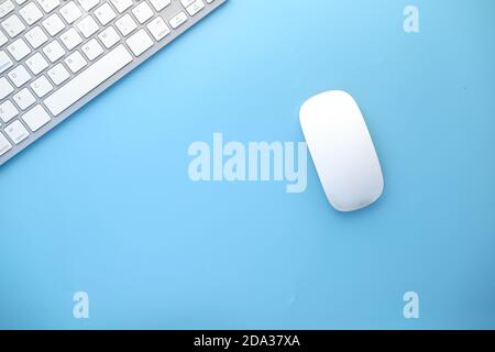 Top view of computer mouse, keyboard on blue background, Stock Photo