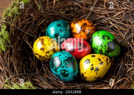 Easter eggs in the decorative nest on wood background Stock Photo
