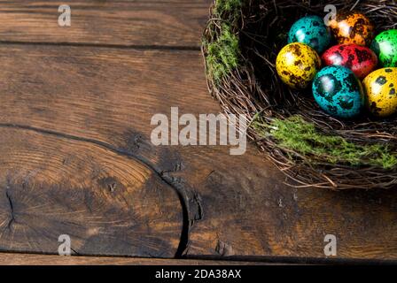 Easter eggs in the decorative nest on wood background Stock Photo