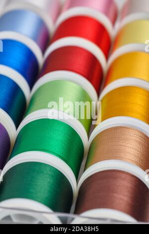 Background from spools with multicolored sewing threads Stock Photo