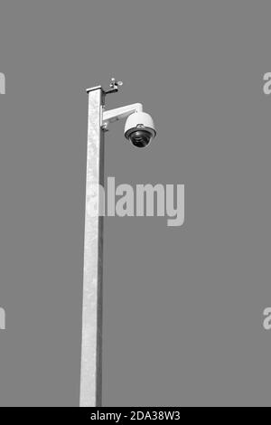 Security camera on white pole, isolated on grey background Stock Photo
