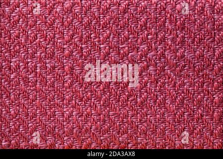 Dark red wicker textile background, closeup. Structure of the purple woven fabric backdrop, macro. Stock Photo