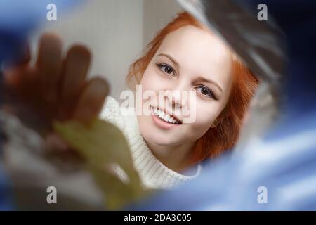 a sweet girl with appetite takes out chips from a pack. view from the pack Stock Photo