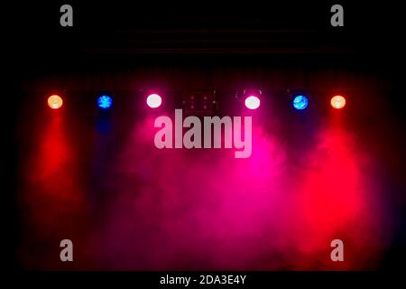 Row of coloured stage lights in a smoky atmosphere. Stock Photo