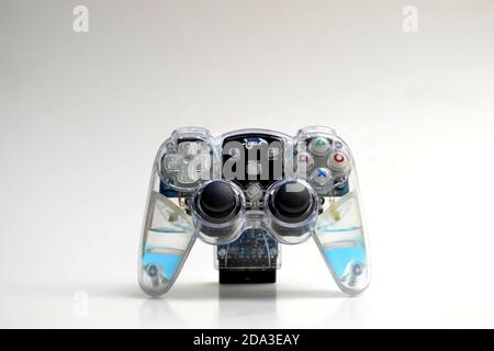 Joystick, video game, color, translucent, transparent, with several control buttons on white background, with copy space, Brazil, South America Stock Photo