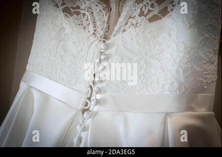 Close up of button details on the back of a beautiful white wedding dress. Stock Photo