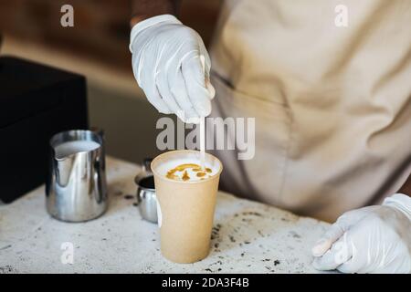 Drawing on cappuccino in modern coffee shop Stock Photo