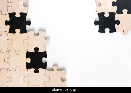 Wooden jigsaw puzzle pieces on white background Stock Photo
