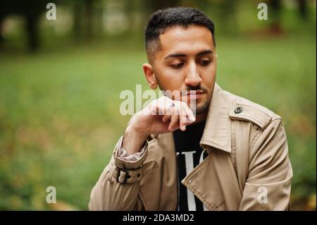 Stylish kuwaiti man at trench coat. Stock Photo