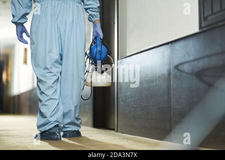 Cropped photo of medical staff wearing protective clothing and disinfecting the public place. Coronavirus and quarantine concept Stock Photo