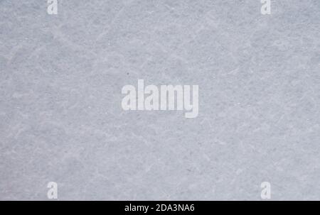 Full frame white and gray surface with shiny patches as a backdrop.  Stock Photo
