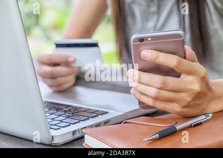 A woman shopping on mobile with credit card Stock Photo
