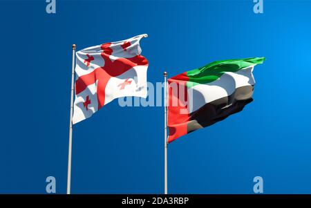 Beautiful national state flags of Georgia and UAE United Arab Emirates together at the sky background. 3D artwork concept. Stock Photo