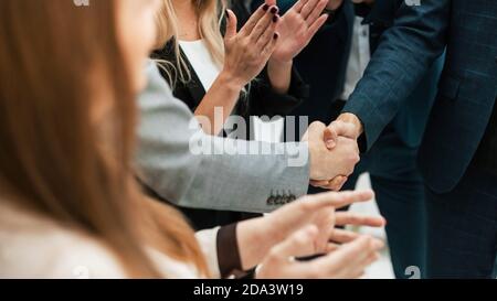 close up. business partners shaking hands in the office. Stock Photo