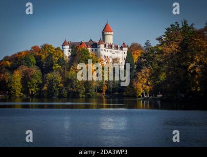 Colorful scenery of autumn season with castle over the lake. Stock Photo