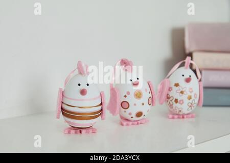 Close up view of cute painted with pink color Easter eggs on shelves indoors Stock Photo