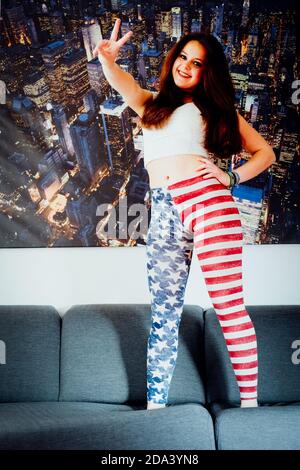 Young teenager wearing american flag leggings and spreading joy