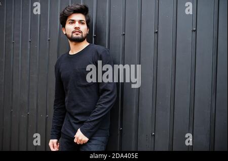 Urban young hipster indian man wear all in black. Cool south asian guy. Stock Photo