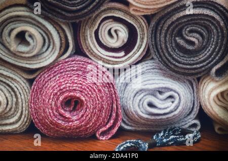 many textile rolls of blue, white and pink colors stacked one over the other Stock Photo