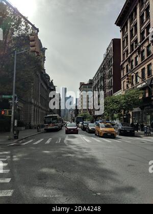 New York City, NY/USA - October 6th 2019: New York City Downtown Manhattan with buildings in the background. Cars and yellow cab taxi standing on red Stock Photo