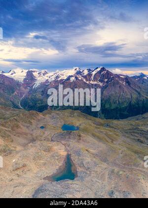 Aerial panoramic of Tresero peak and lake Manzina at sunset, Stelvio National Park, Valfurva, Valtellina, Lombardy, Italy Stock Photo