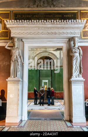 Berlin, Germany – January 29, 2018. Interior view of Neues Museum in Berlin, toward the bust of Egyptian queen Nefertiti, with people gathered around Stock Photo