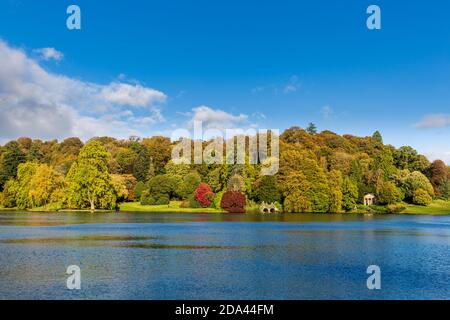 Autumn colour across the lake at Stourhead in Wiltshire, England Stock Photo