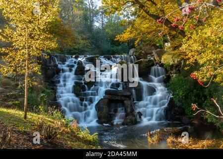 The ornamental cascade or waterfall at Virginia Water Lake in Windsor Great Park during autumn, England, UK Stock Photo