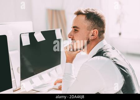 dreams of a young businessman sitting at office Desk Stock Photo