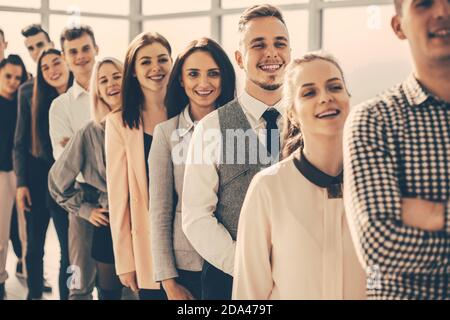 group of diverse young people standing in a long queue Stock Photo