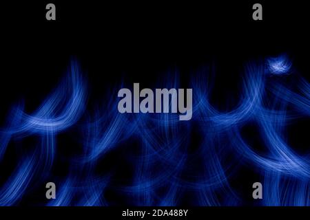 Wallpaper with bright curved lines and flame of blue color. Background with copy space for screen or banner text. Lightpainting effect. Stock Photo