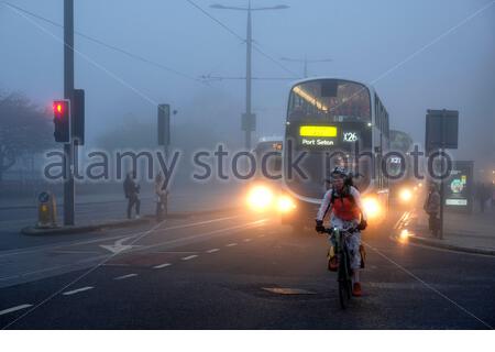 Edinburgh, Scotland, UK. 9th Nov 2020. Thick Afternoon fog persists in the city centre, buses and cyclists seen here in Princes Street.  Credit: Craig Brown/Alamy Live News Stock Photo
