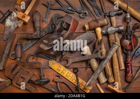 Collection of old vintage tools on a workbench. Stock Photo