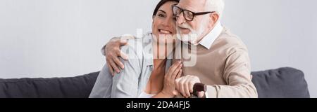 aged man and social worker embracing at home, banner Stock Photo