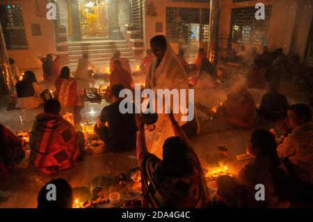 Hindu devotees sit together on the floor of a temple to observe Rakher Upabash, in Sylhet, Bangladesh. Stock Photo