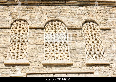 Patterned stone windows of medieval building in the Icheri Sheher old city of Baku, Azerbaijan Stock Photo