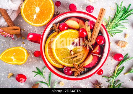 Mulled Wine Hot Drink with Citrus and Spices, Traditional Autumn Winter Warm Alcohol Beverage, in small portioned red stewpan or mug  with Mulled Wine Stock Photo