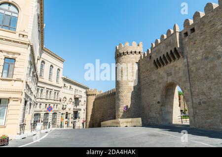 Baku, Azerbaijan – July 4, 2020. View of Old City walls, Old City gates, and Aziz Aliyev street in Baku. View of an empty street with commercial prope Stock Photo