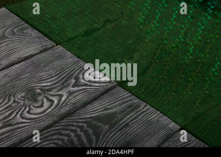 Brushed pine boards painted black and white. The iridescent surface is green. Stock Photo
